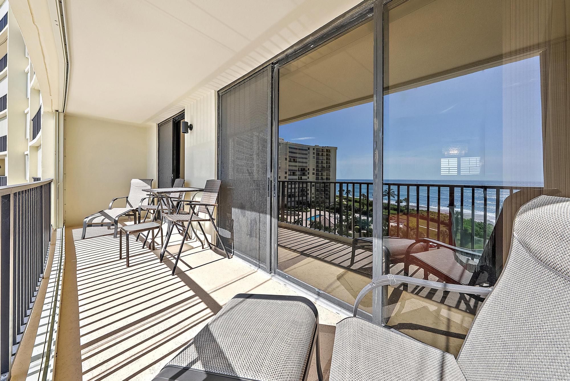 400 Ocean Trail Way, Unit 707 Jupiter, FL 33477 - Photo 20 of 34 a view of a chairs and table on the balcony