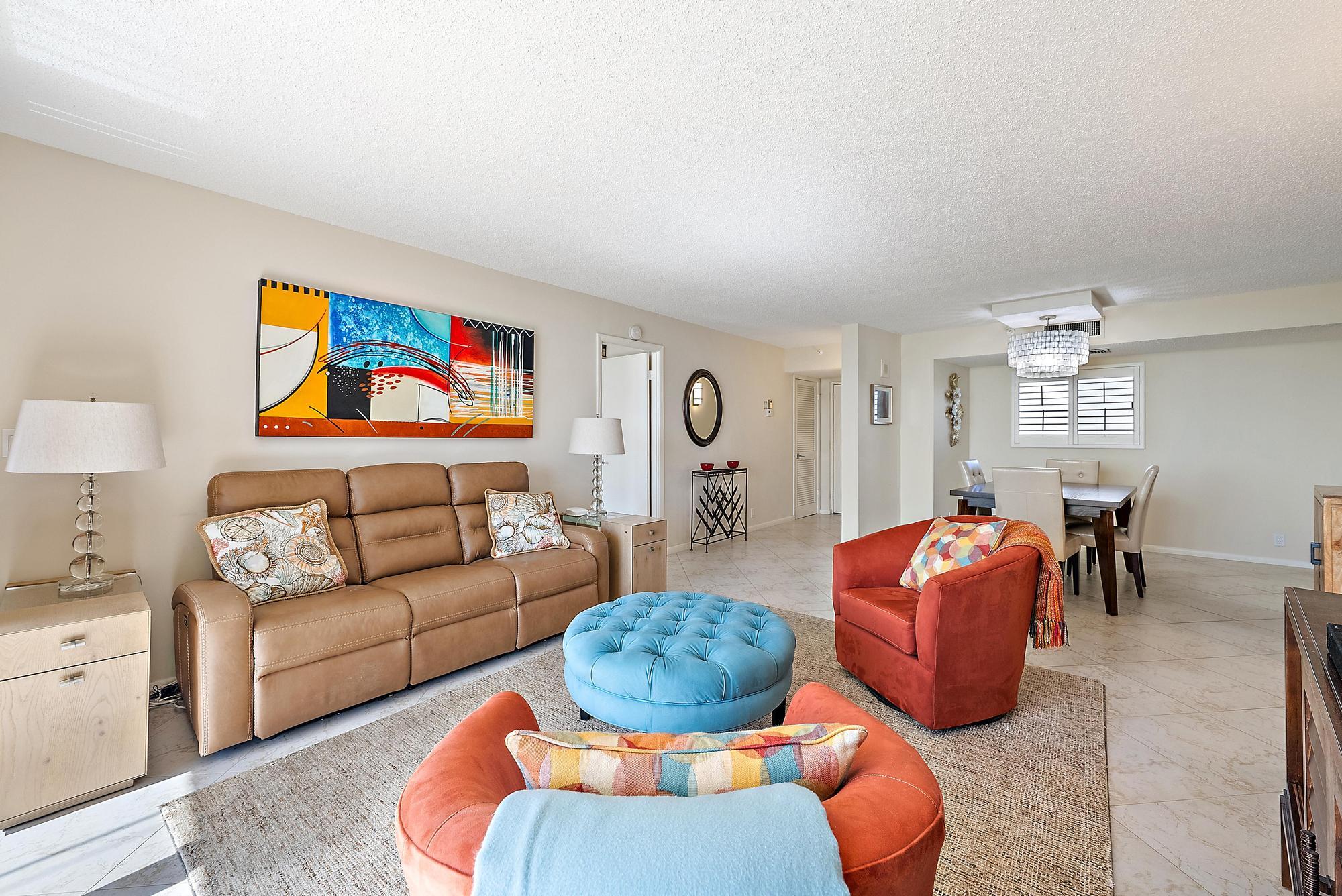 400 Ocean Trail Way, Unit 707 Jupiter, FL 33477 - Photo 7 of 34 a living room with furniture a rug and kitchen view