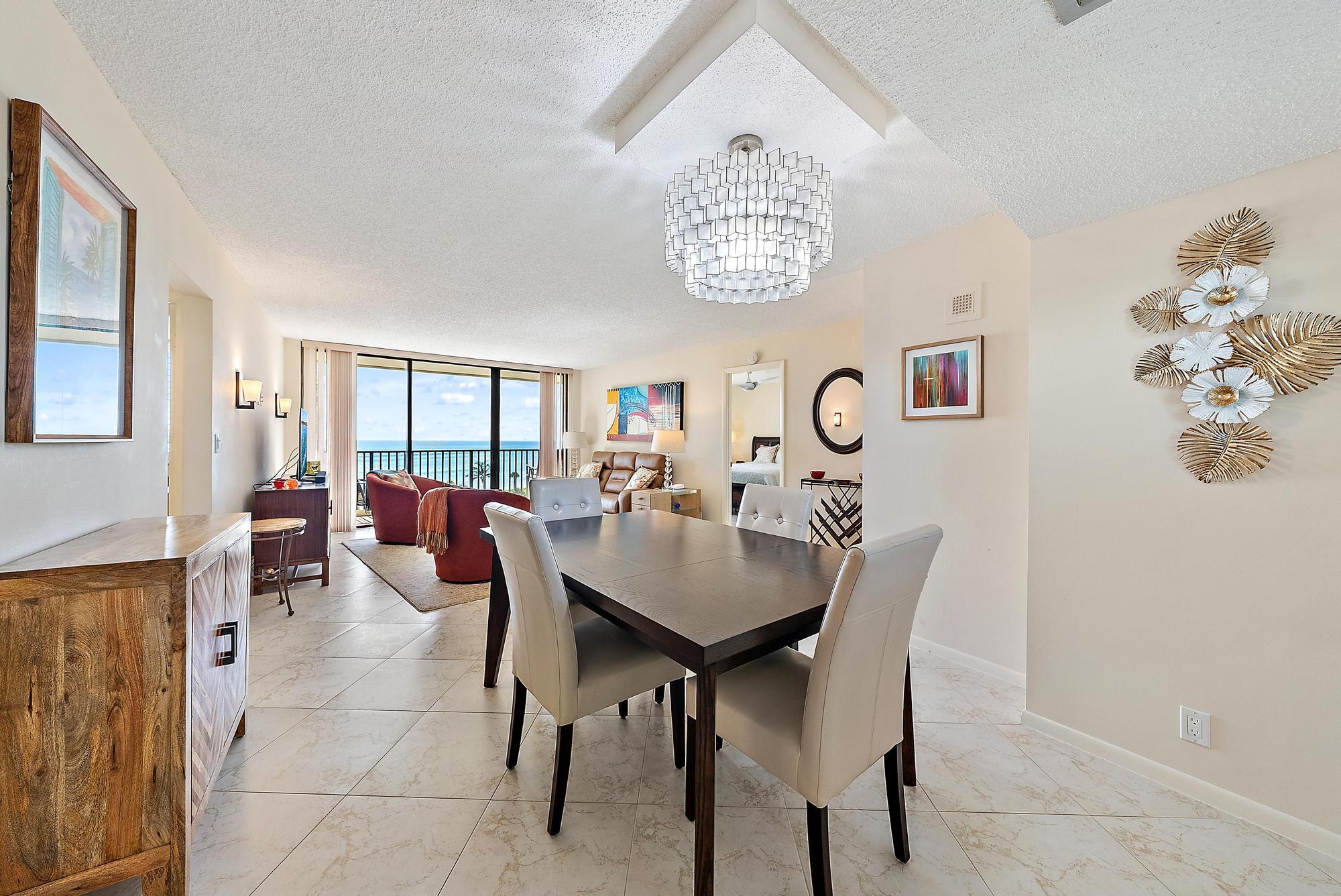 400 Ocean Trail Way, Unit 707 Jupiter, FL 33477 - Photo 8 of 34 a view of a dining room with furniture and chandelier