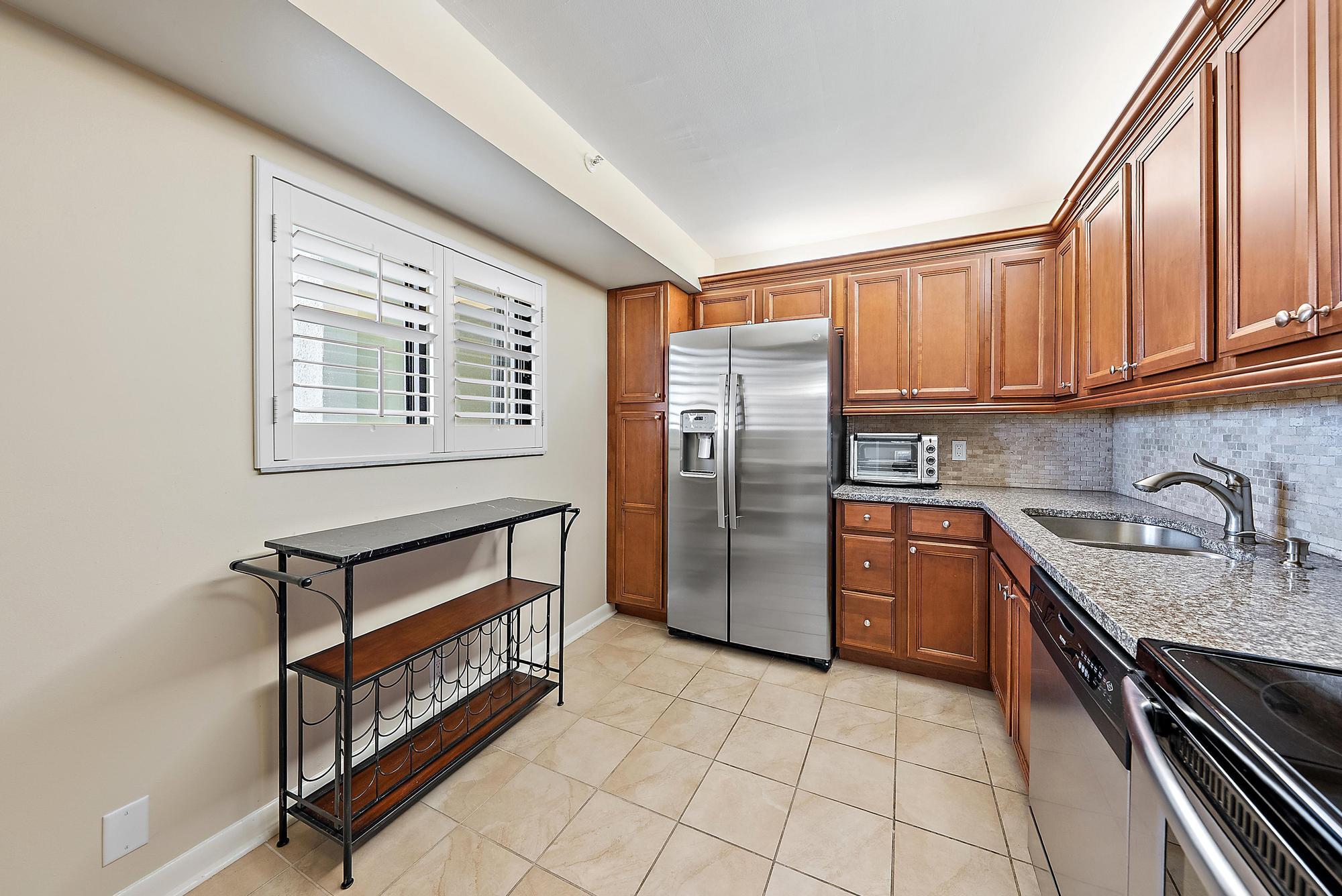 400 Ocean Trail Way, Unit 707 Jupiter, FL 33477 - Photo 10 of 34 a kitchen with stainless steel appliances granite countertop a stove top oven a sink and dishwasher