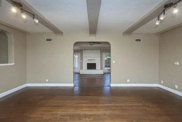 a large kitchen with stainless steel appliances granite countertop a stove a sink dishwasher and a refrigerator