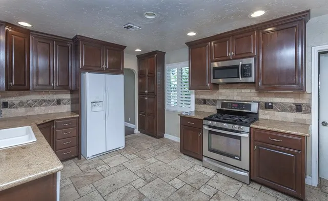 a view of room with hardwood floor and a ceiling fan