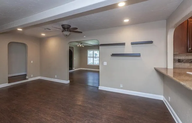 a bathroom with a granite countertop tub a double vanity sink and a large mirror