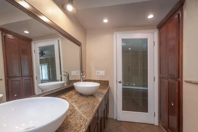 a backyard of a house with table and chairs