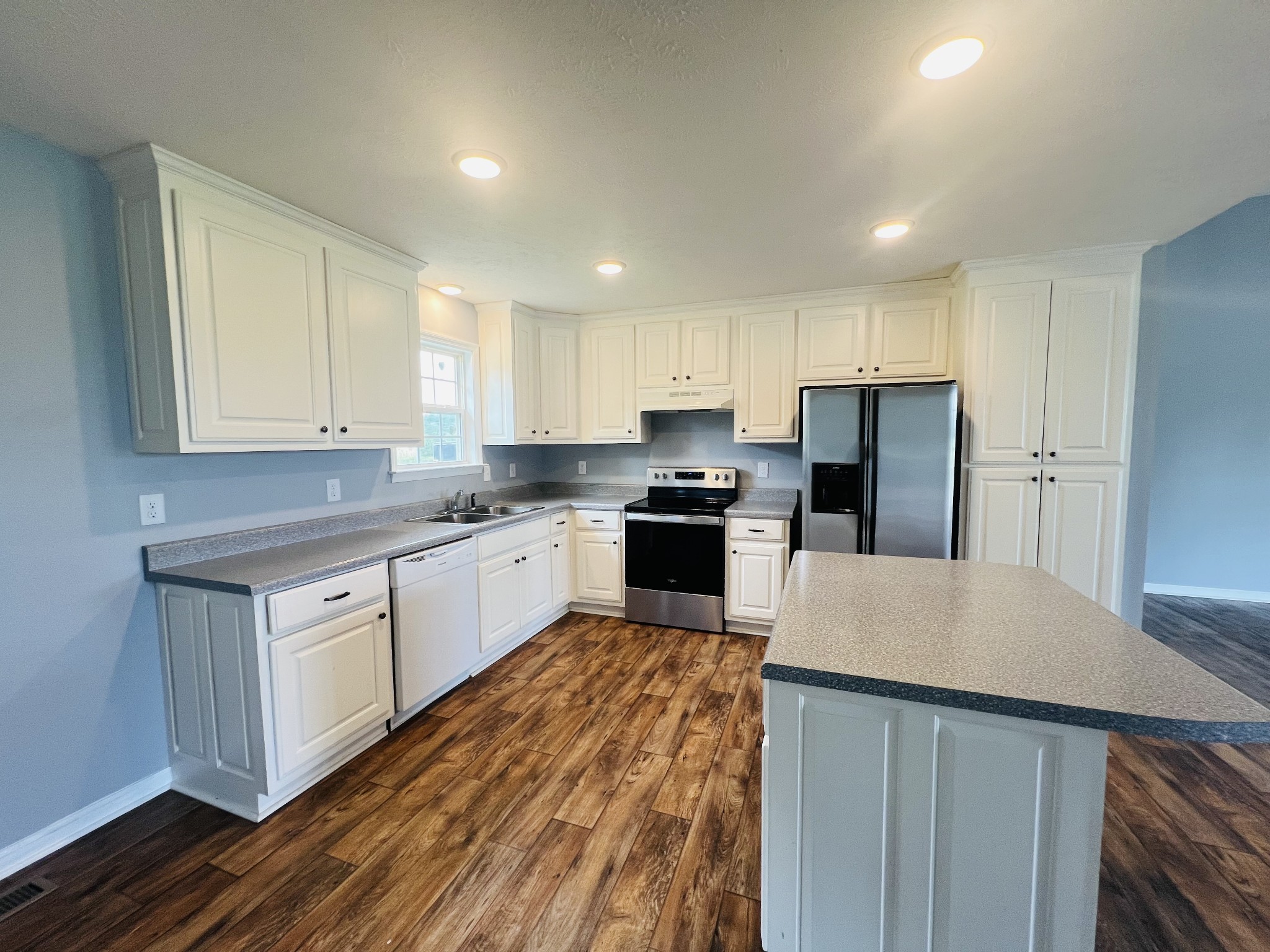 4560 Fall River Road Pulaski, TN 38478 - Photo 7 of 28 a kitchen with granite countertop white cabinets and white appliances