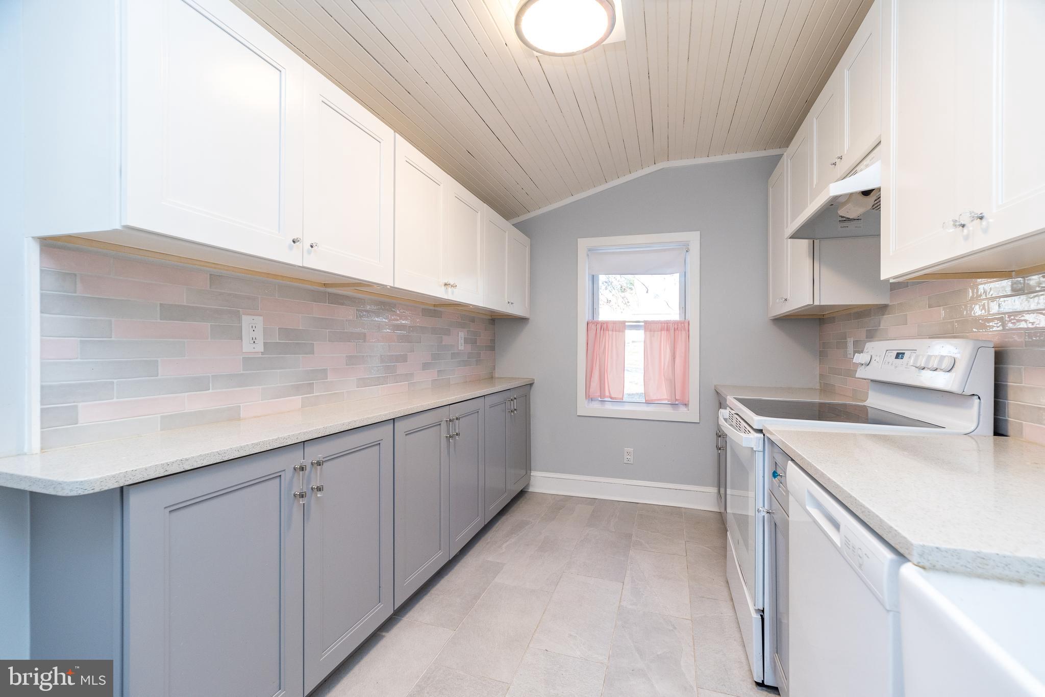 4924 Ridge Avenue Feasterville-Trevose, PA 19053 - Photo 9 of 38 a kitchen with cabinets appliances a sink and a window