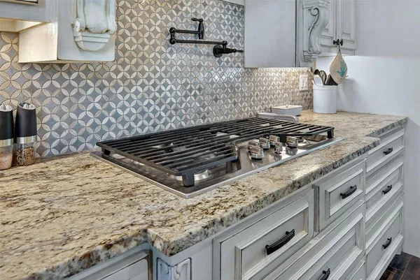 a stove top oven sitting inside of a kitchen