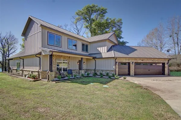 a view of a building with a yard and sitting area