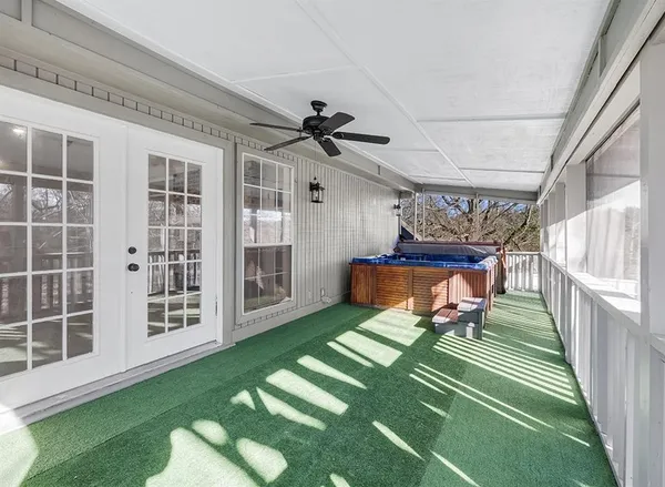 a view of a porch with furniture and a yard