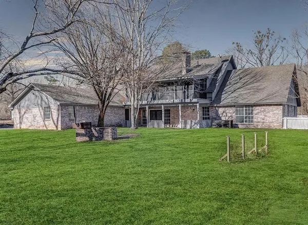 a view of a house with backyard and sitting area