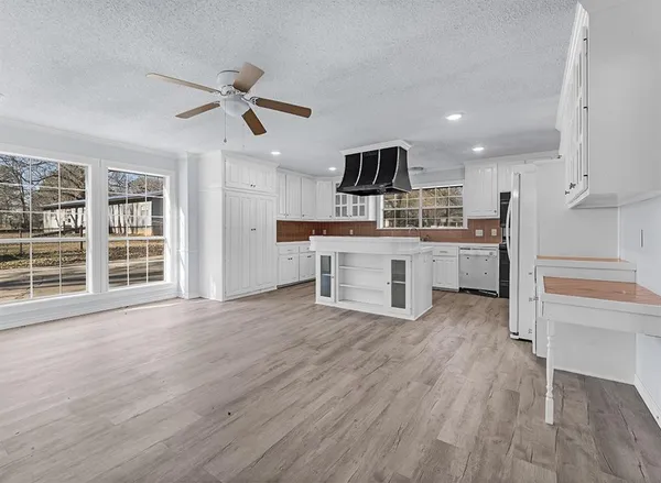 a view of kitchen with sink microwave refrigerator and stove
