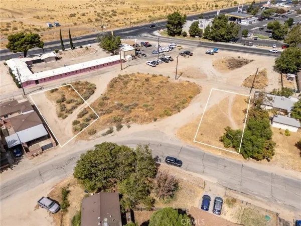 an aerial view of a house with a yard and lake view