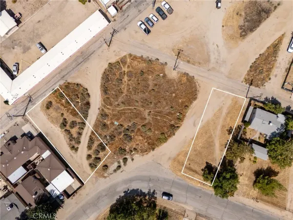 an aerial view of a house a yard and mountain view in back