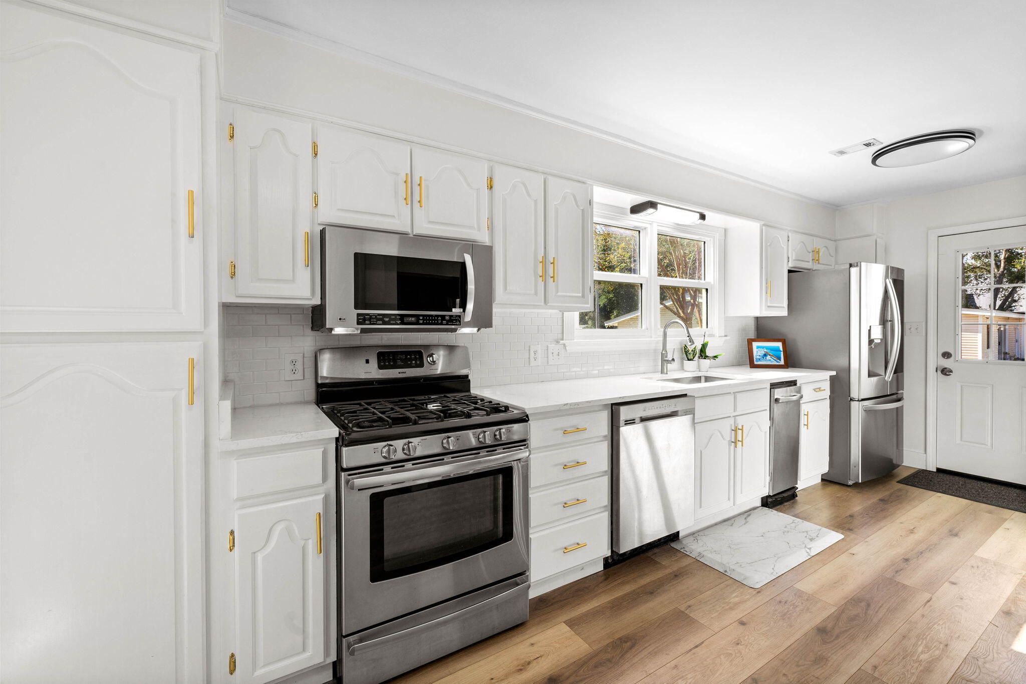 710 Beach Drive Destin, FL 32541 - Photo 11 of 64 a kitchen with white cabinets and appliances