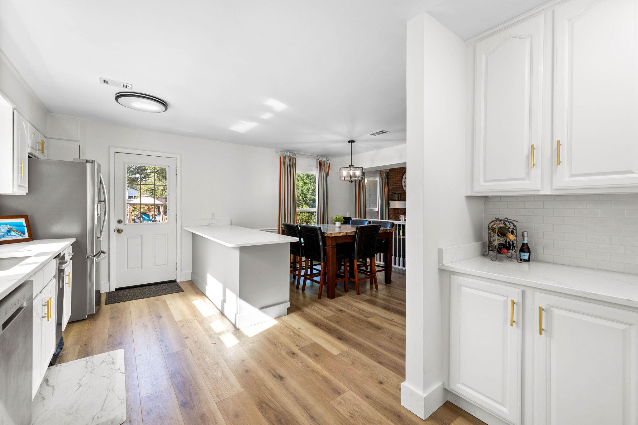 710 Beach Drive Destin, FL 32541 - Photo 12 of 64 a kitchen with stainless steel appliances refrigerator cabinets and wooden floor