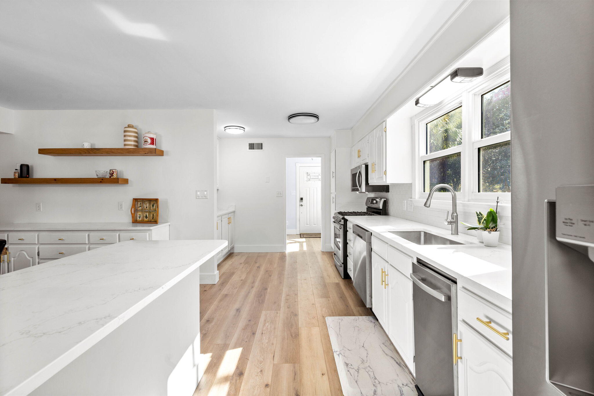 710 Beach Drive Destin, FL 32541 - Photo 13 of 64 a large kitchen with a lot of counter space and wooden floor