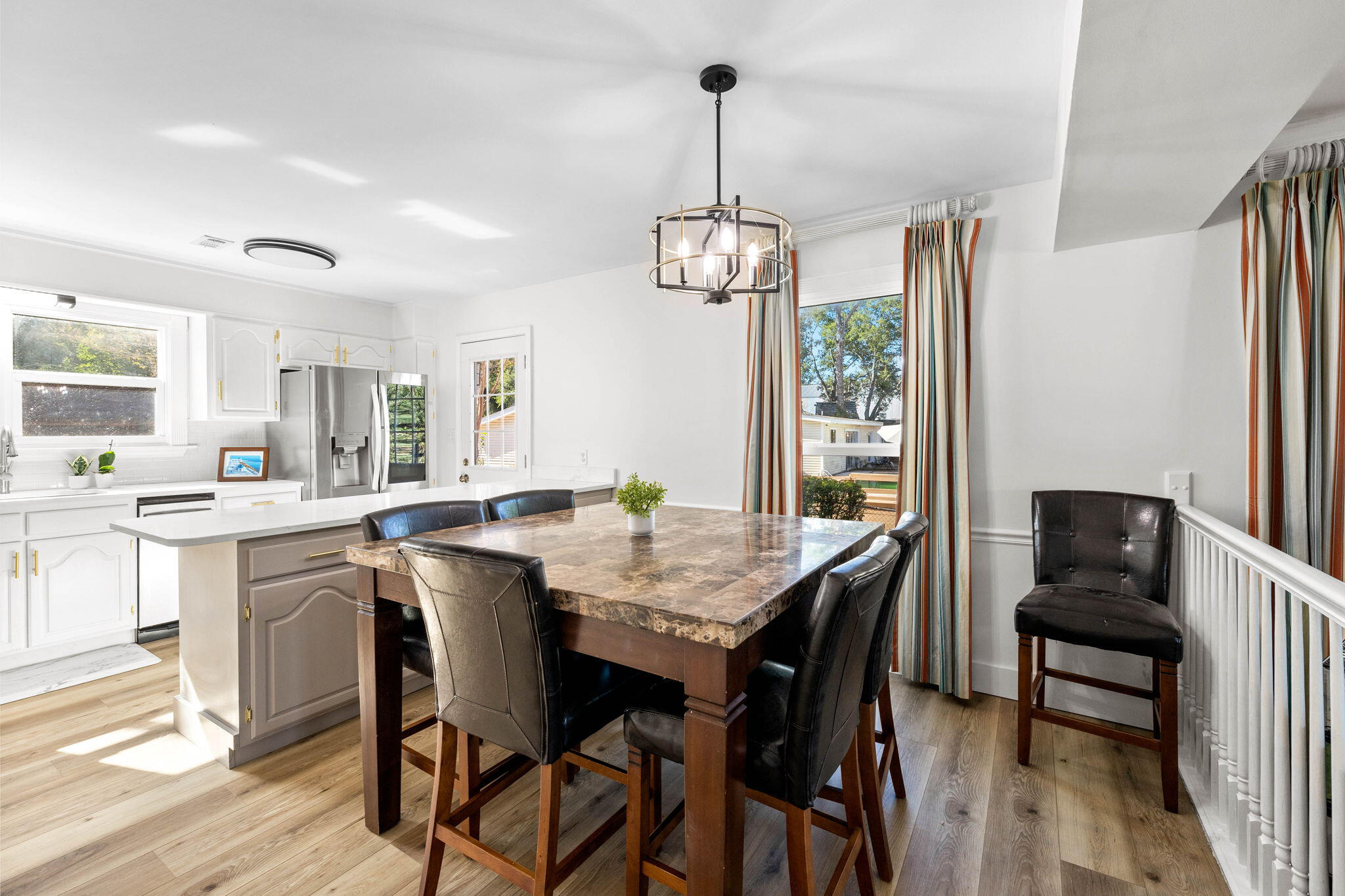 710 Beach Drive Destin, FL 32541 - Photo 16 of 64 a view of a dining room with furniture window and wooden floor