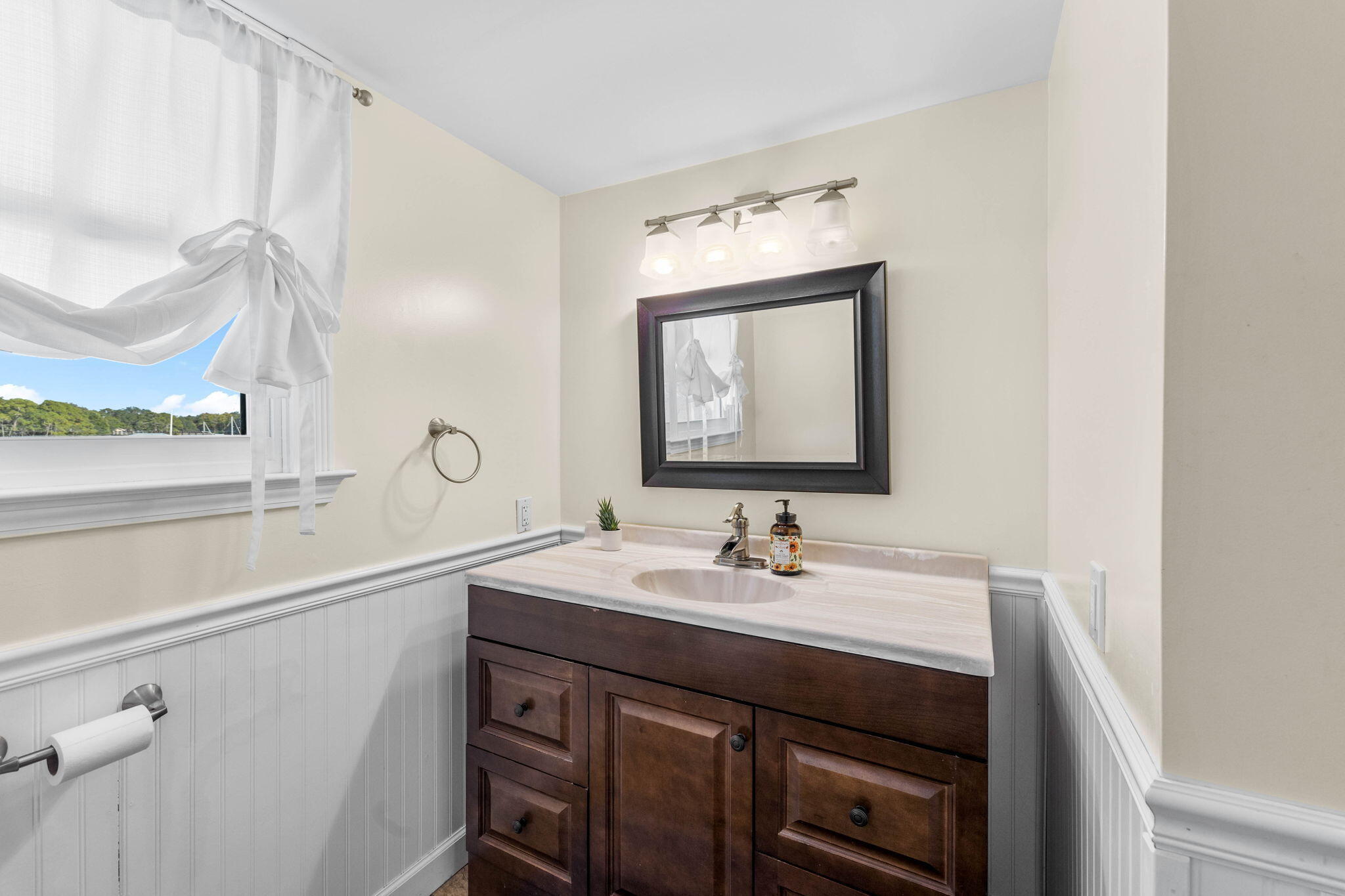 710 Beach Drive Destin, FL 32541 - Photo 26 of 64 a bathroom with a sink vanity and a mirror