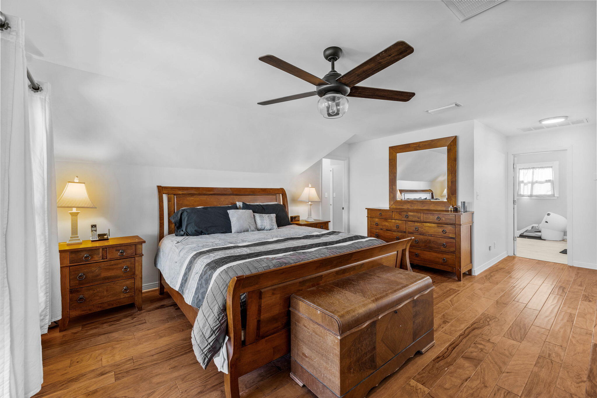 710 Beach Drive Destin, FL 32541 - Photo 29 of 64 a bedroom with a bed and a chandelier