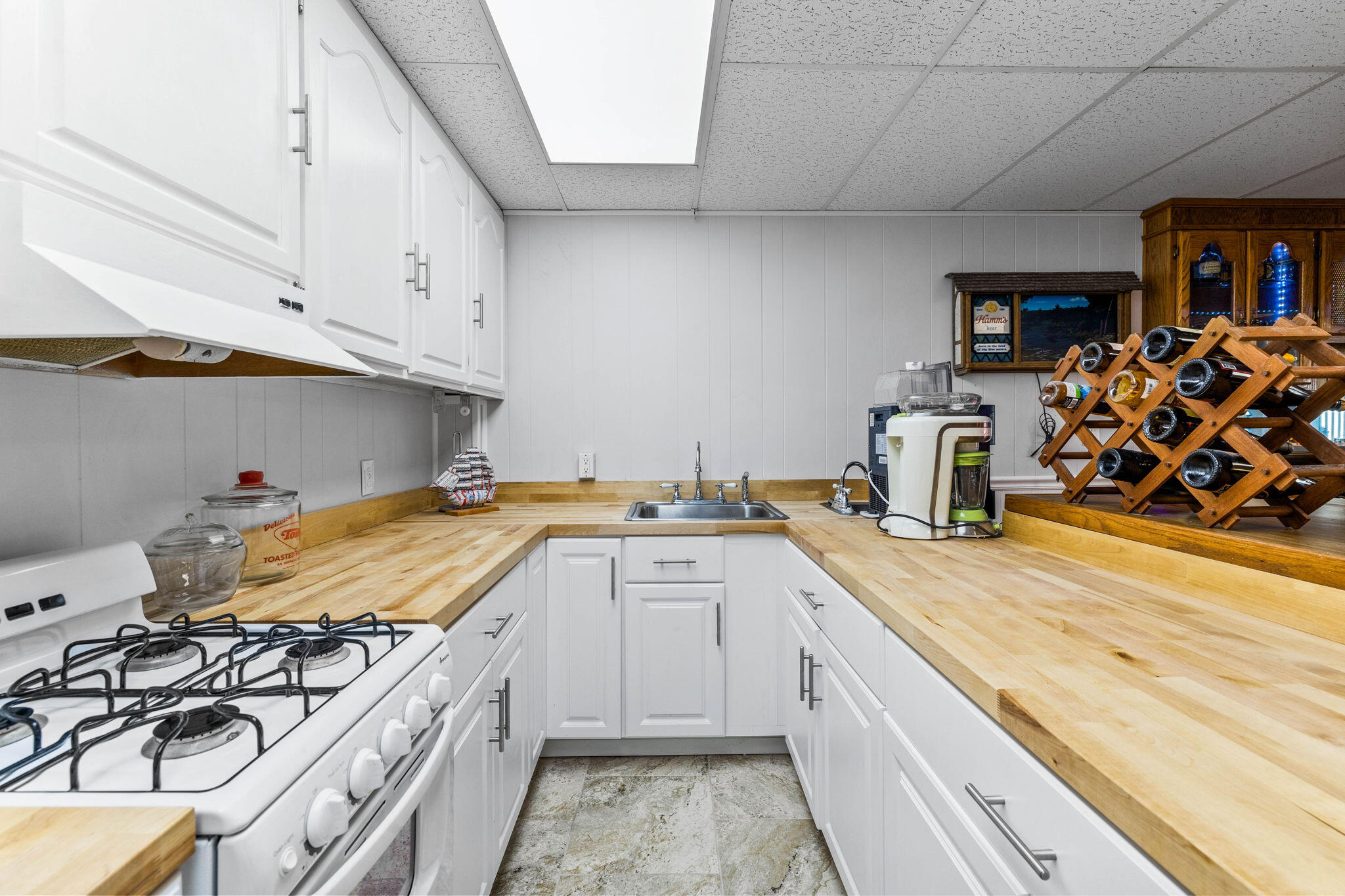 710 Beach Drive Destin, FL 32541 - Photo 39 of 64 a kitchen with a sink a stove and cabinets