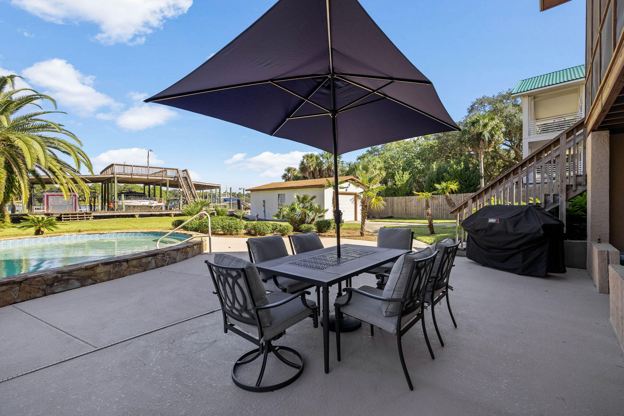 710 Beach Drive Destin, FL 32541 - Photo 46 of 64 a view of a table and chairs under an umbrella