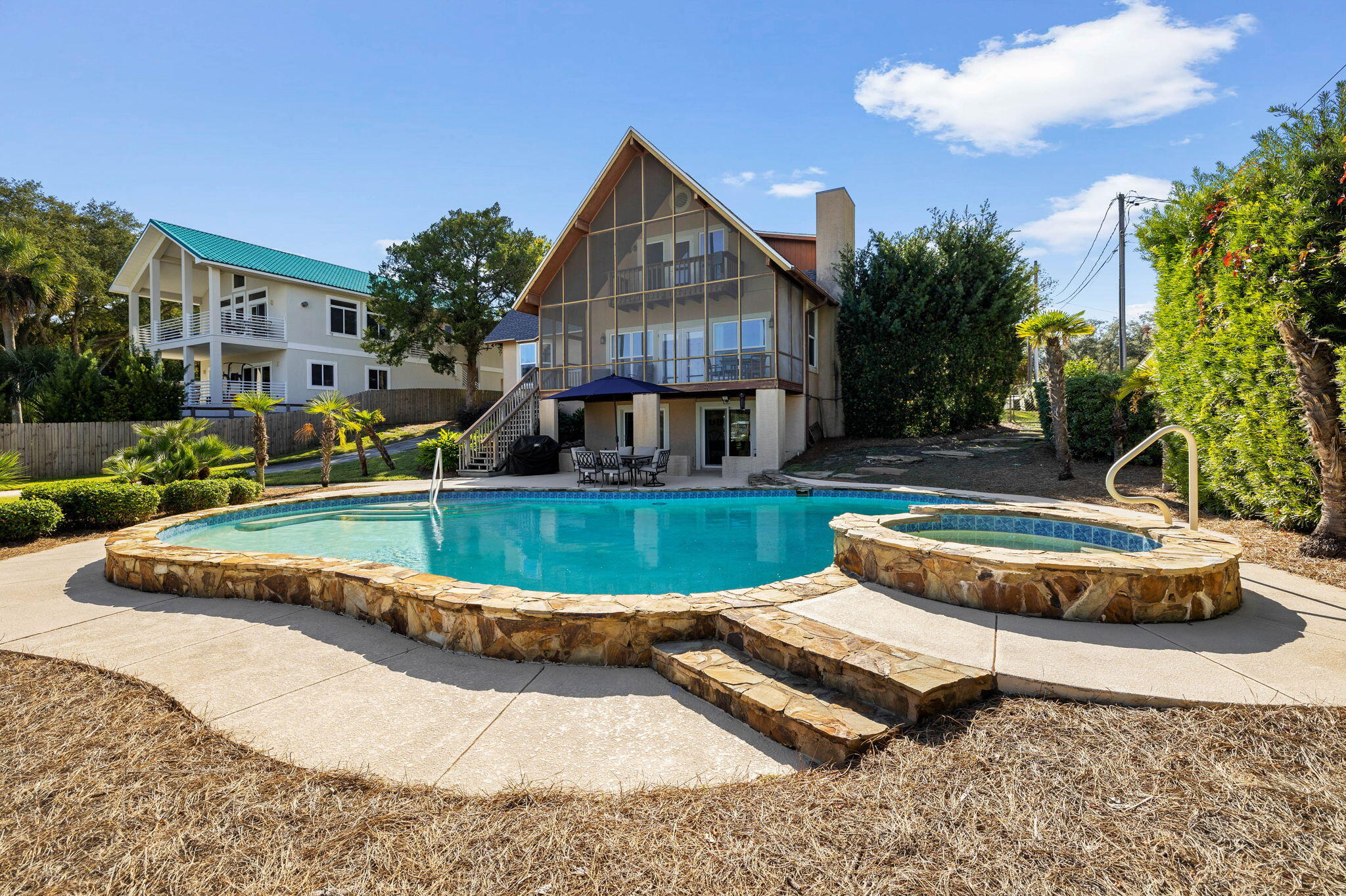 710 Beach Drive Destin, FL 32541 - Photo 48 of 64 a view of a house with swimming pool and a yard