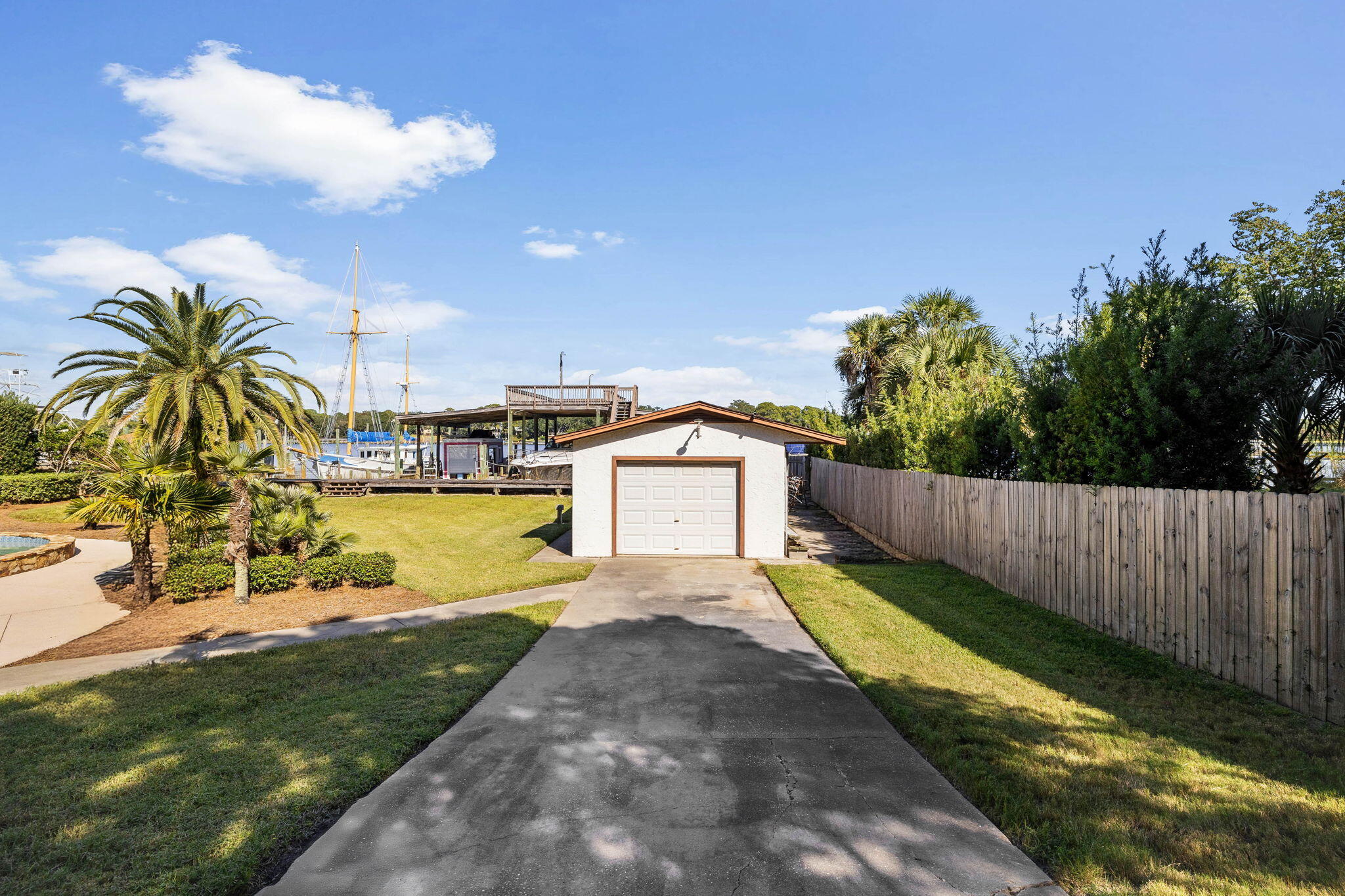 710 Beach Drive Destin, FL 32541 - Photo 51 of 64 a view of a yard with swimming pool in front of house