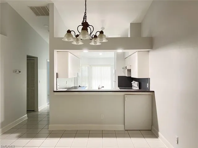 a kitchen with a sink and chandelier