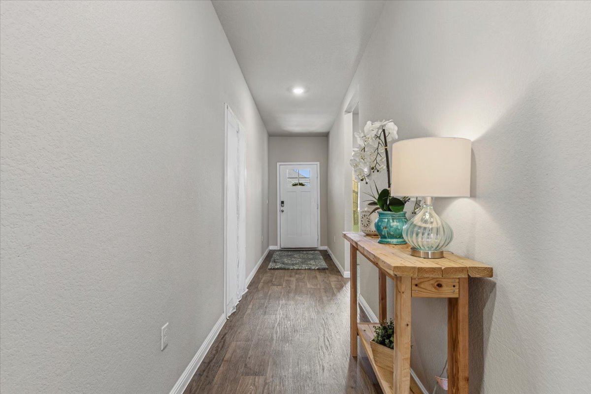 112 Rainmaker Cove Bastrop, TX 78602 - Photo 13 of 34 Entryway featuring wood finished floors, a textured wall, and recessed lighting