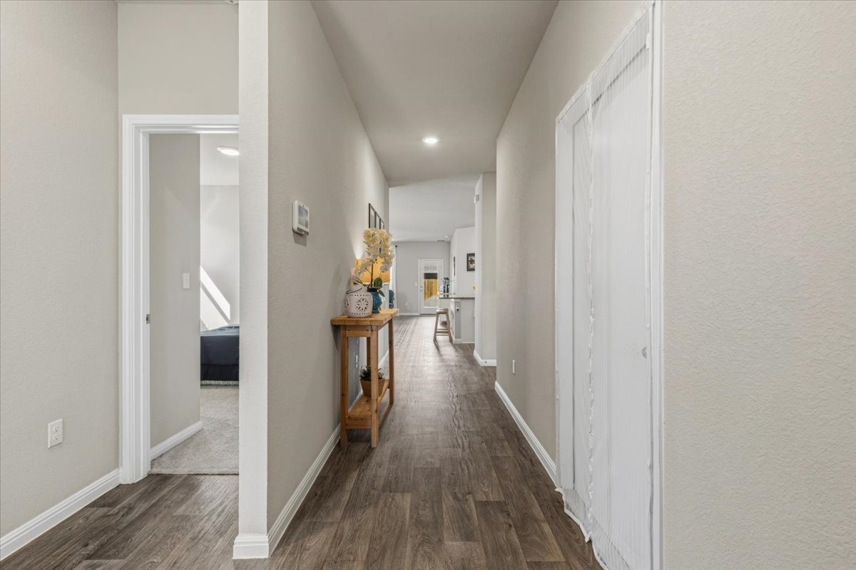 112 Rainmaker Cove Bastrop, TX 78602 - Photo 14 of 34 Corridor with dark wood-style flooring and recessed lighting