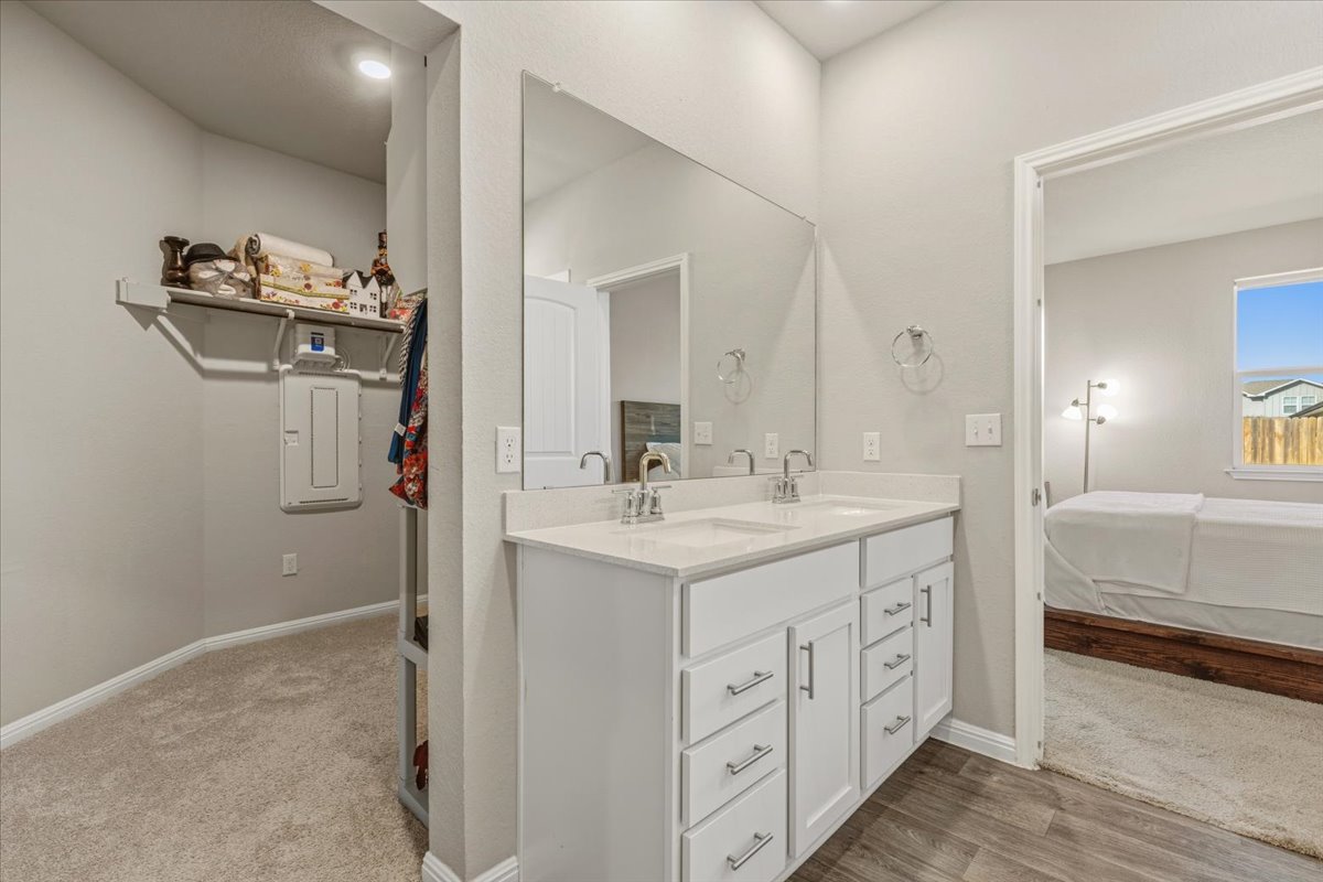 112 Rainmaker Cove Bastrop, TX 78602 - Photo 18 of 34 Ensuite bathroom with double vanity and electric panel