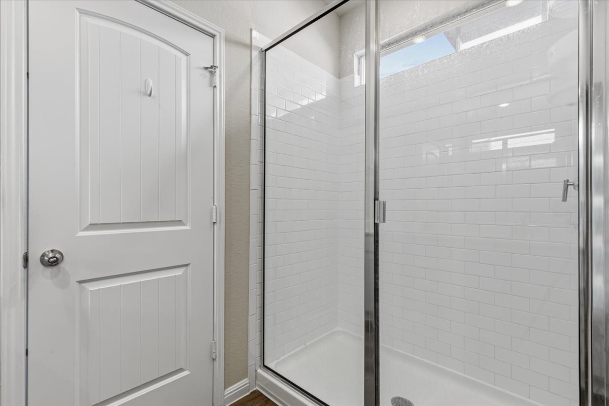 112 Rainmaker Cove Bastrop, TX 78602 - Photo 20 of 34 Full bathroom with a stall shower