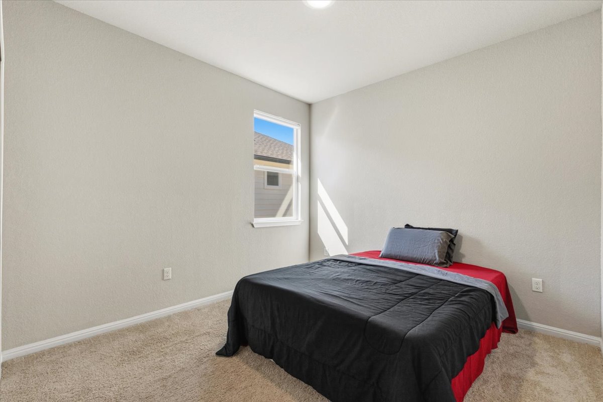 112 Rainmaker Cove Bastrop, TX 78602 - Photo 21 of 34 Bedroom with light colored carpet