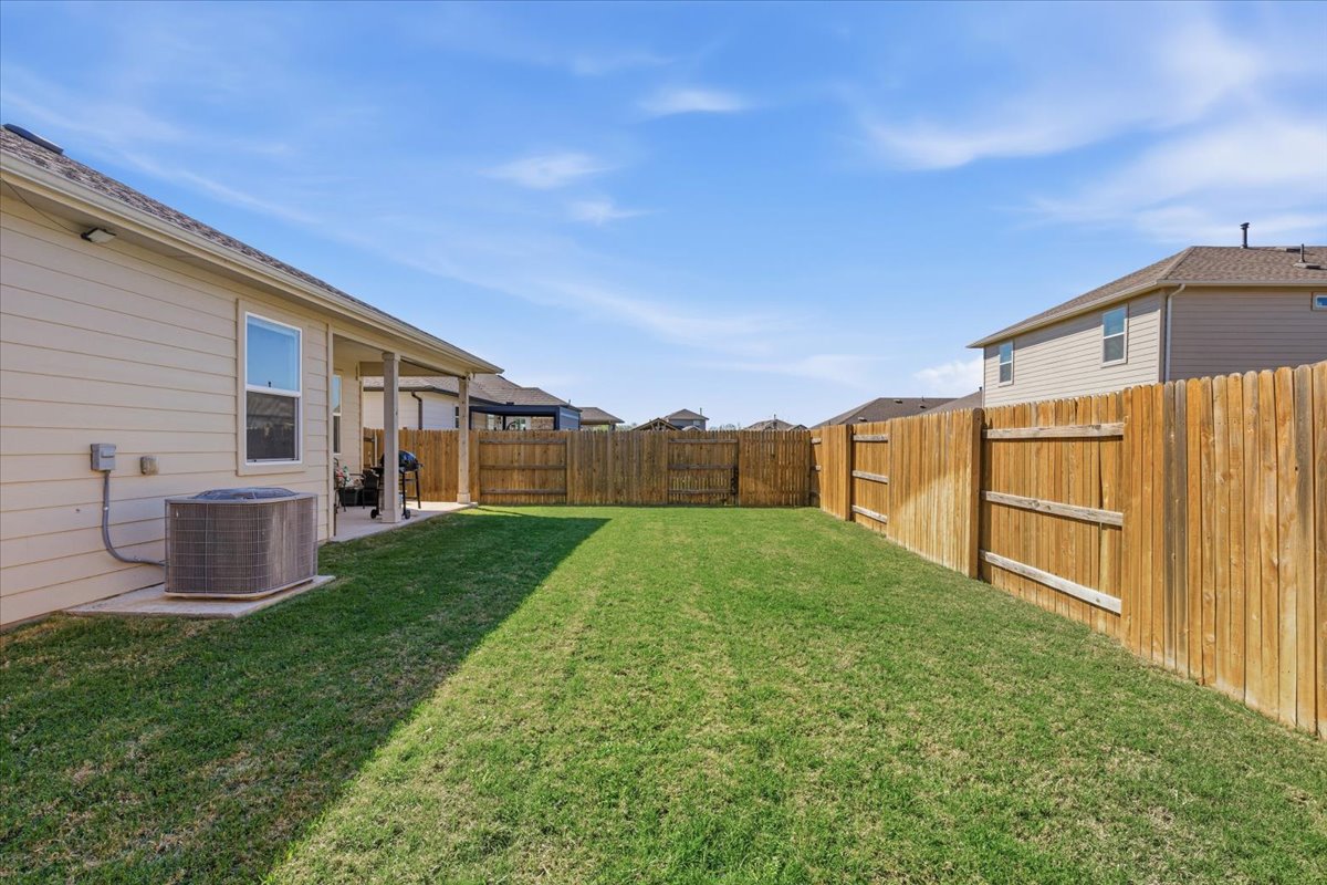 112 Rainmaker Cove Bastrop, TX 78602 - Photo 26 of 34 Fenced backyard featuring a patio
