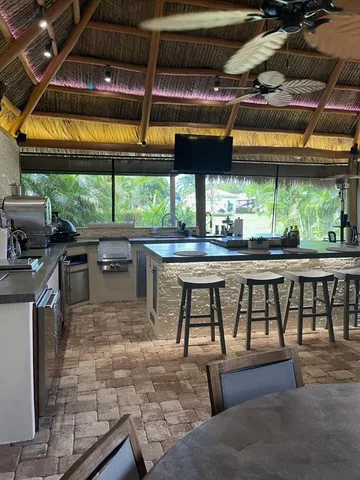 a view of a kitchen with a table and chairs