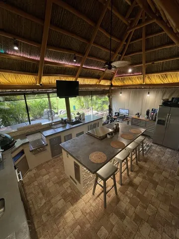 a view of a patio with a table and chairs under an umbrella