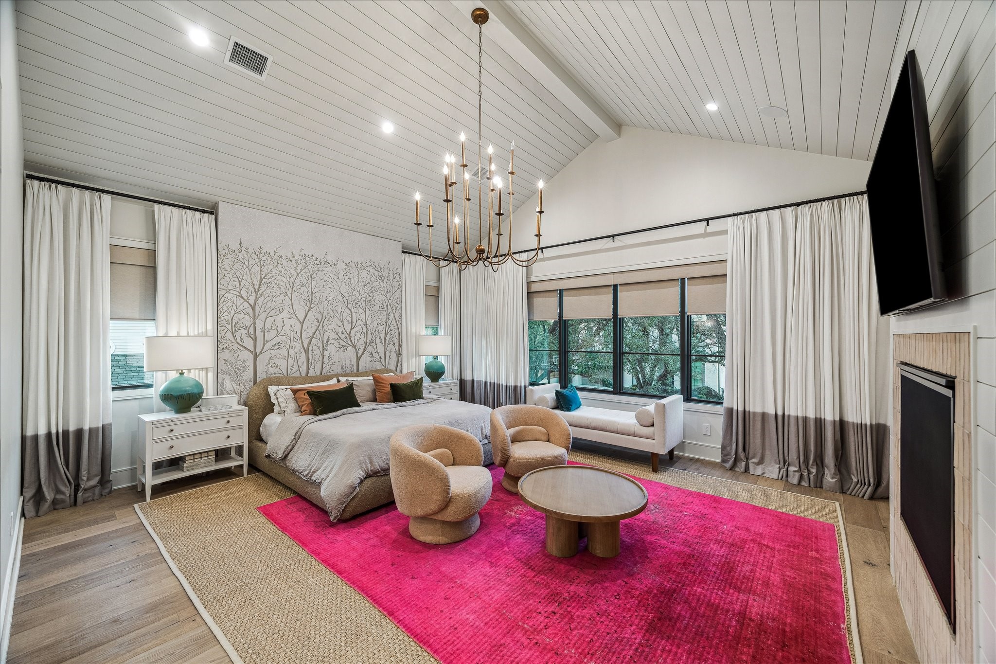 3807 Westerman Street Houston, TX 77005 - Photo 27 of 50 Soaring vaulted ceilings with rich wood detailing and a statement chandelier define the elegance of the primary retreat, seamlessly connecting to the luxurious en suite bath beyond.