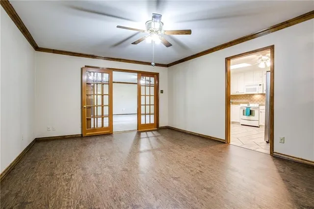 wooden floor in an empty room with a window
