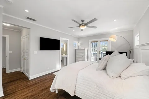 a large bedroom with a bed and a flat screen tv
