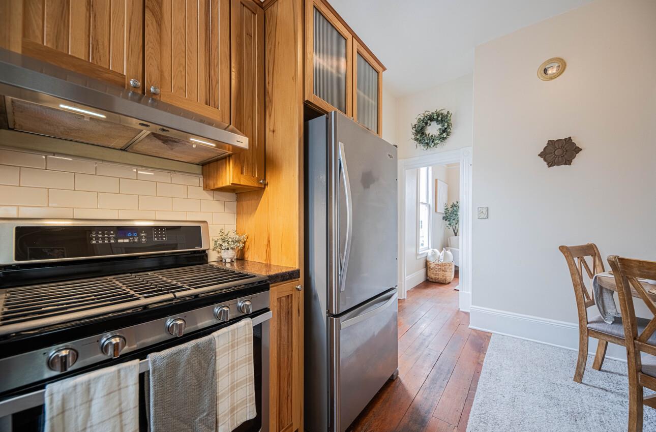 332 Capitol Street Salinas, CA 93901 - Photo 18 of 41 a kitchen with stainless steel appliances a refrigerator a stove and a sink with wooden floor
