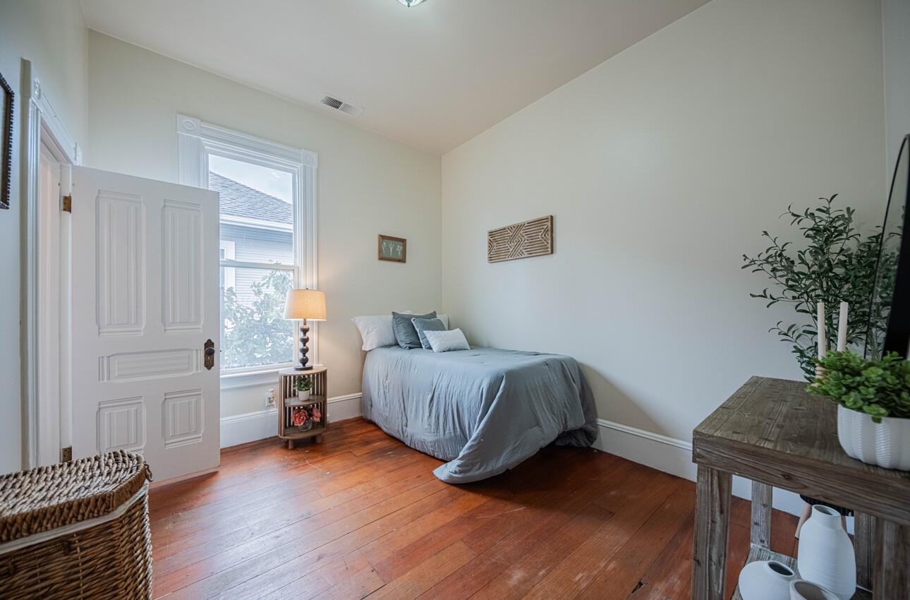 332 Capitol Street Salinas, CA 93901 - Photo 27 of 41 a spacious bedroom with a bed and a potted plant