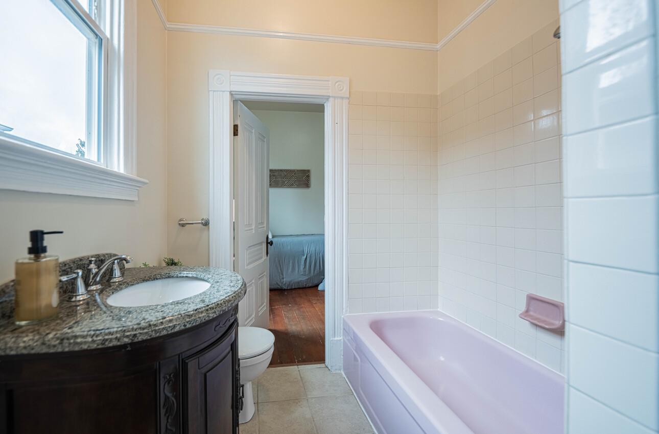332 Capitol Street Salinas, CA 93901 - Photo 30 of 41 a bathroom with a granite countertop sink and a bathtub
