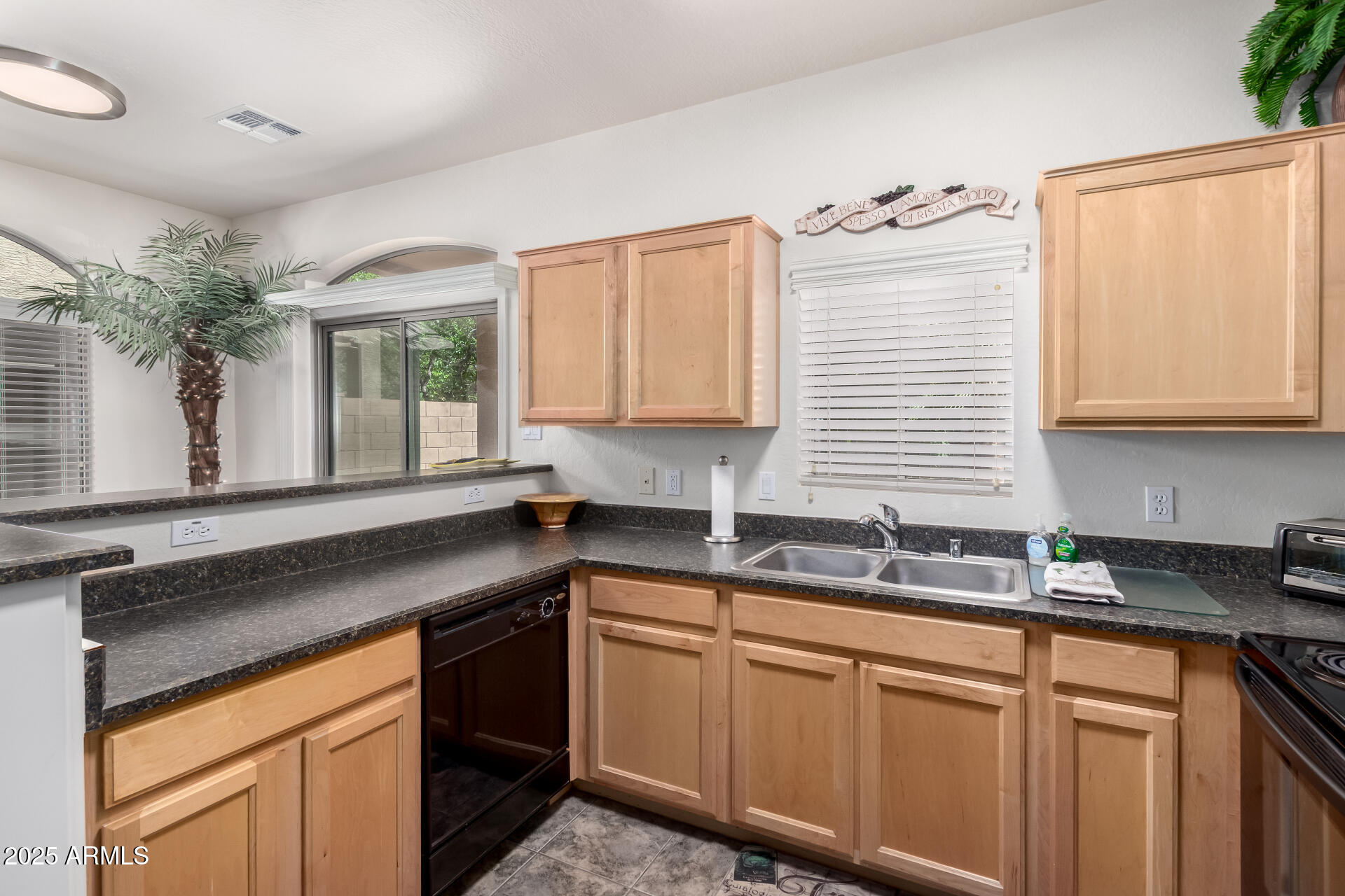 2024 South Baldwin, Unit 99 Mesa, AZ 85209 - Photo 10 of 78 a kitchen with granite countertop a sink cabinets and window