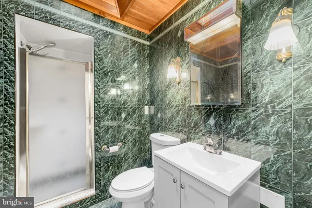 a bathroom with a toilet sink and a mirror