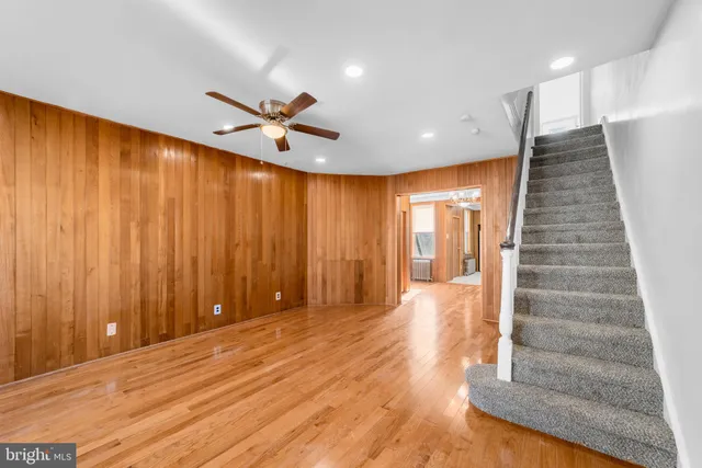 a view of a room with a staircase and a ceiling fan