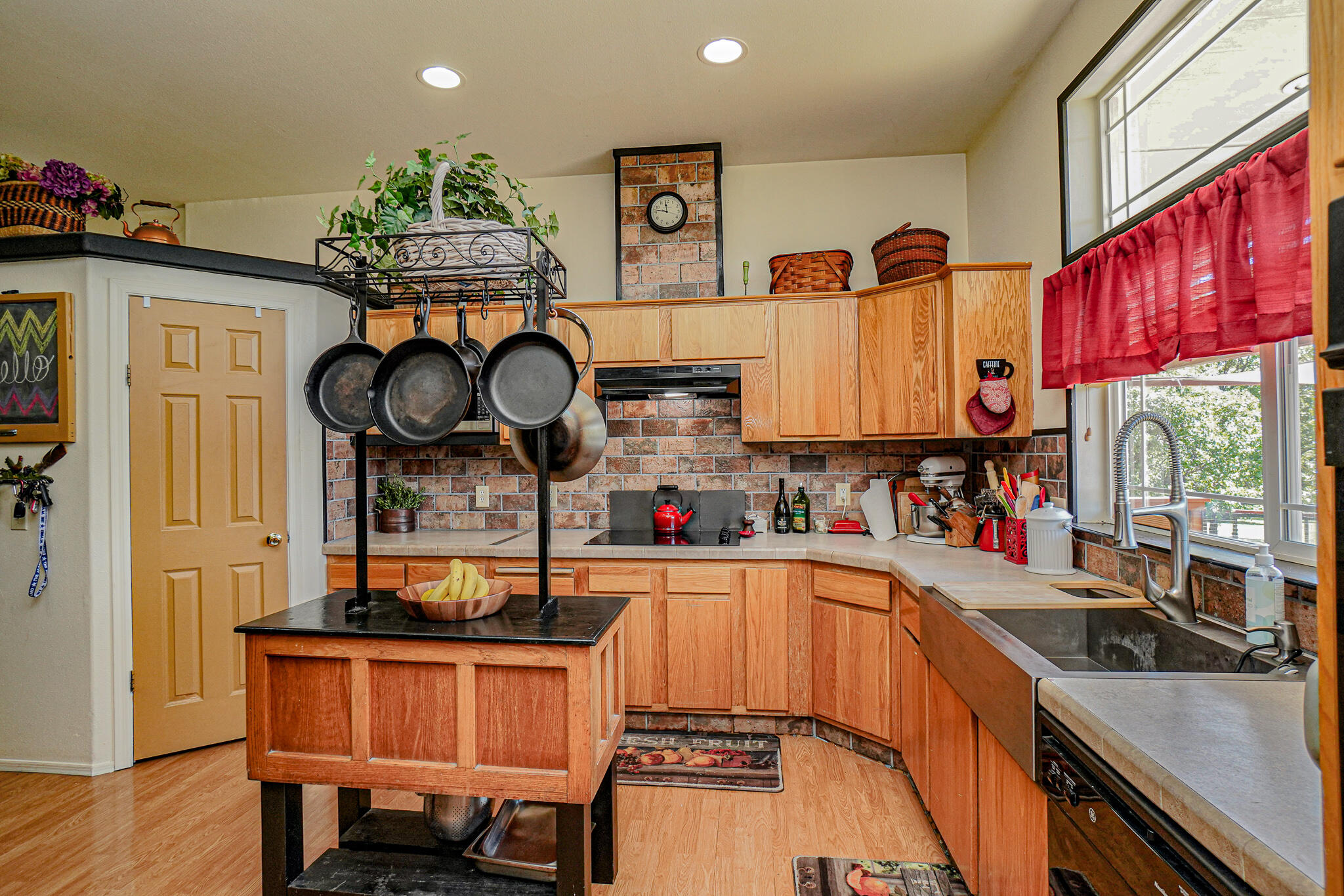 6297 Dodge Road White City, OR 97503 - Photo 12 of 45 a kitchen with stainless steel appliances granite countertop a sink a stove and a wooden floors