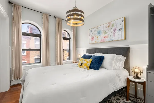 a bedroom with bed and a window