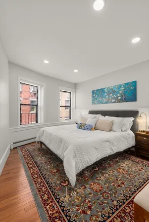 a bedroom with a large bed and a window