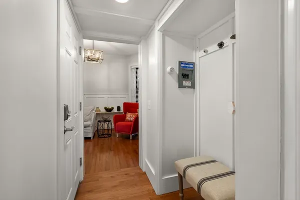 a view of a hallway with couch and a dining room