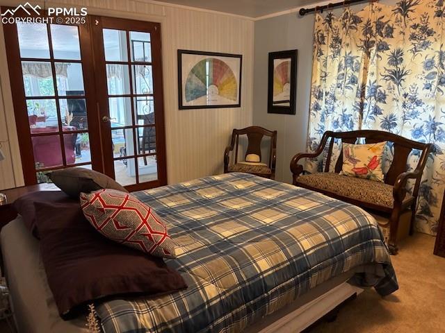 8201 Old San Isabel Road Rye, CO 81069 - Photo 12 of 30 Bedroom with light colored carpet, ornamental molding, wallpapered walls, and french doors